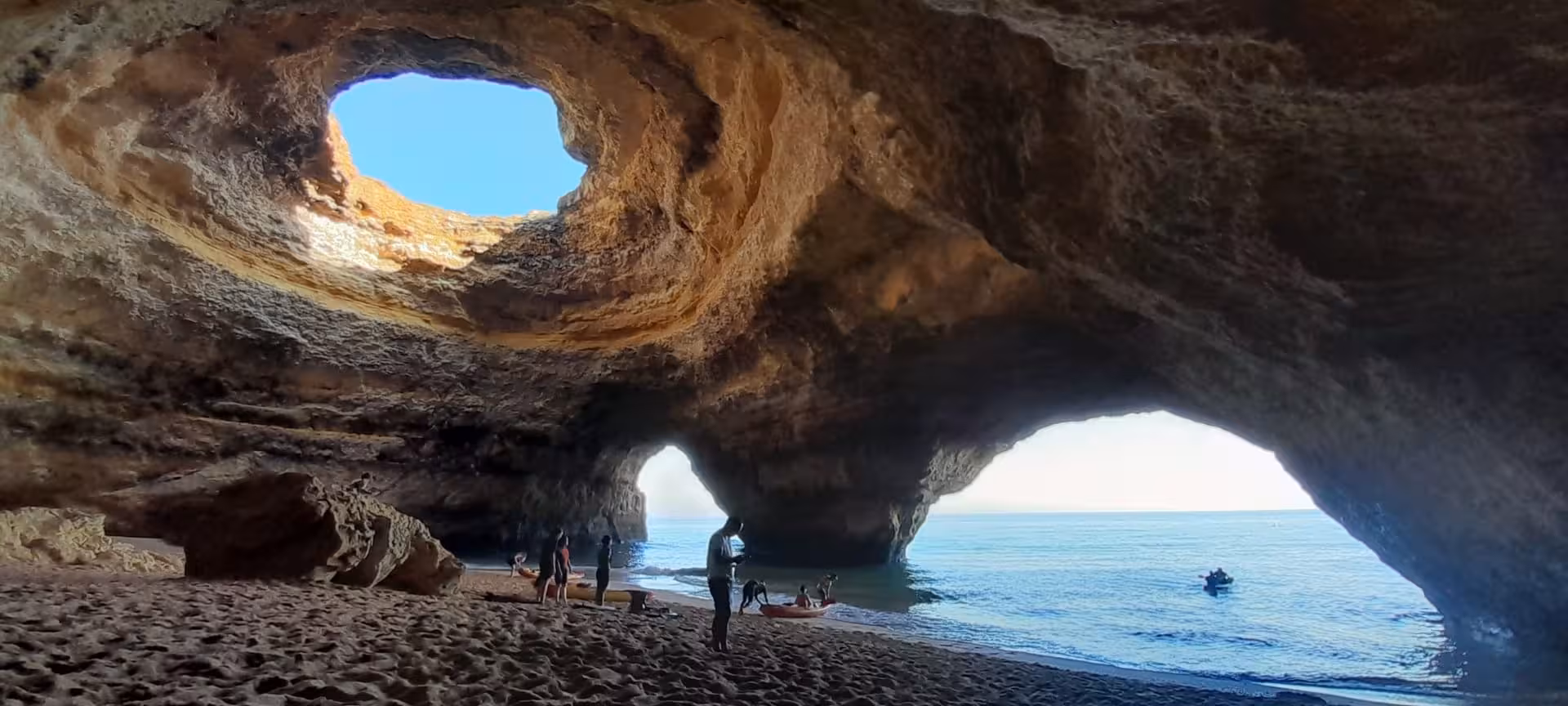 Inside Benagil Sea Cave Algarve with skylight dome and sandy beach, ideal stop on Benagil kayak rental tour