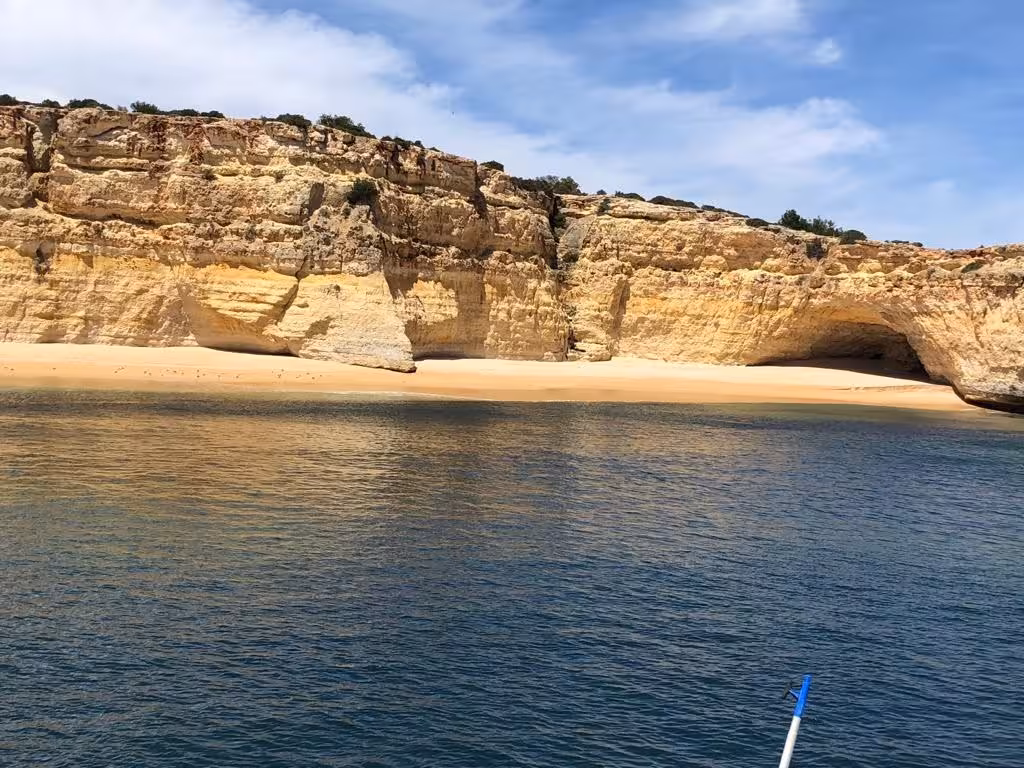 Explore Benagil's stunning cliffs and sandy beaches on the Benagil Sunset Ophelia tour's scenic coastal cruise.