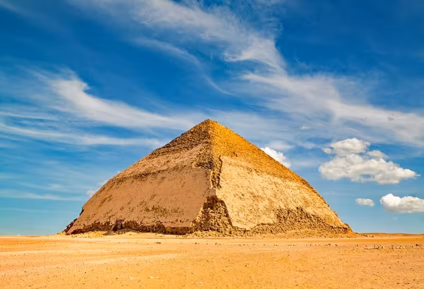 Bent Pyramid at Dahshur near Sakkara, Cairo ultra tour desert view with blue sky and ancient limestone layers