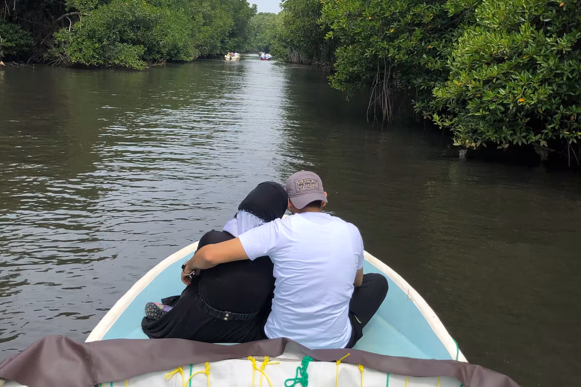 Couple cruising Bentota River safari boat through lush mangroves, scenic Sri Lanka wildlife river tour
