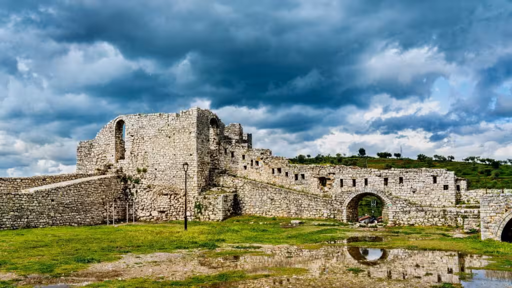 Explore the historic Berat Castle with its ancient stone walls and scenic landscape on a day trip in Albania.