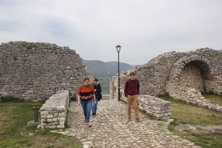Visitors explore the ancient stone pathways and ruins of Berat Castle, capturing the essence of Albanian heritage.