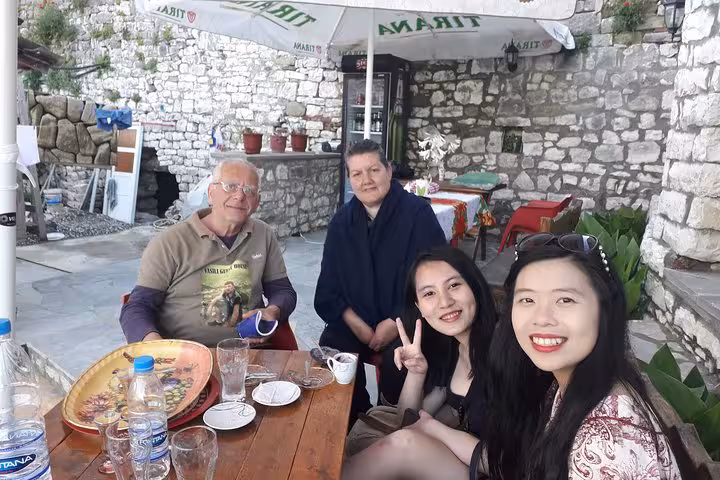 Visitors enjoying a local café in Berat, showcasing cultural connections on a premium walking tour with expert guides.
