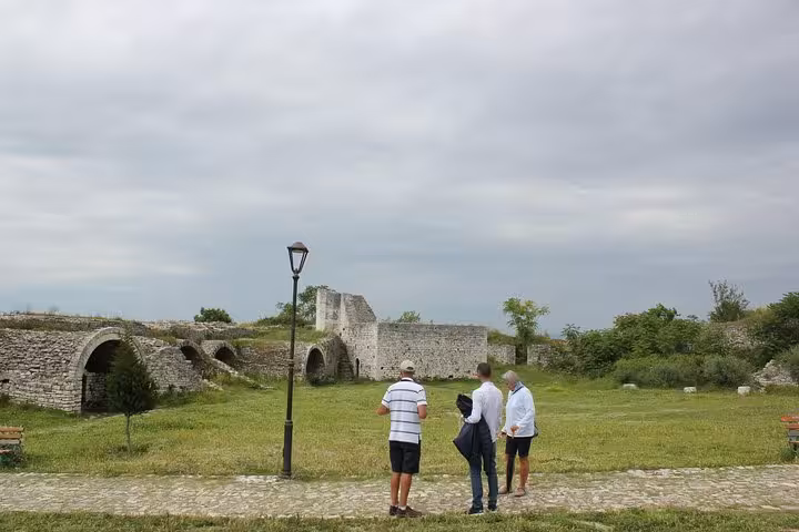 Tourists admiring the medieval ruins in Berat, Albania, while on an expertly guided walking tour.