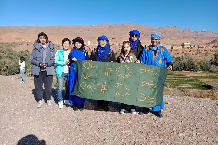 Travelers with Berber guide in Atlas Mountains on private 6-day desert tour Casablanca to Marrakech