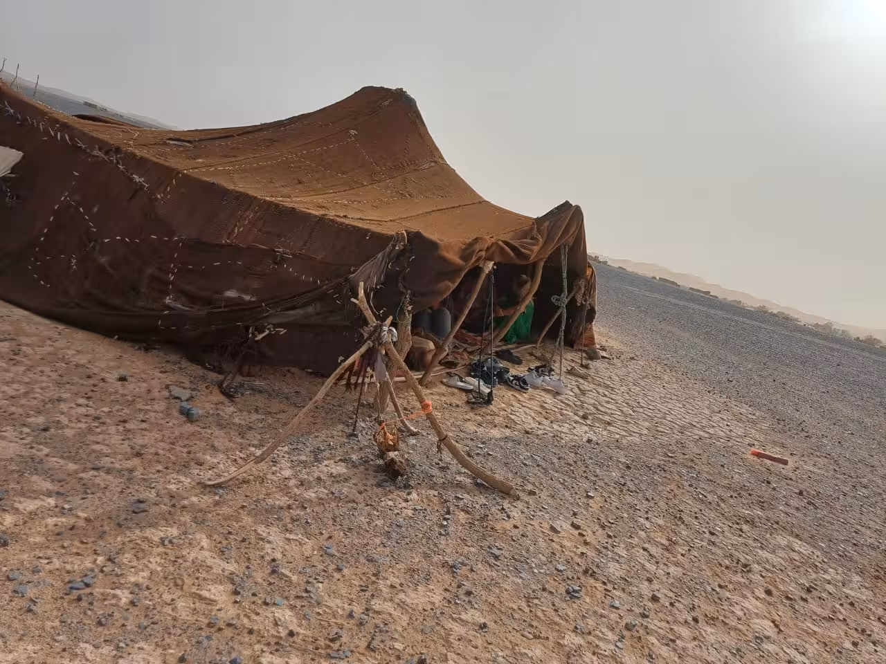 Authentic Berber tent in the Merzouga Desert, showcasing traditional nomadic lifestyle on a Fes to Errachdia tour.