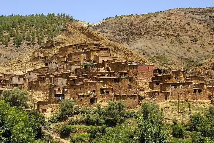 Traditional Berber village on Atlas Mountains hillside in Ourika Valley, scenic day trip from Marrakech Morocco