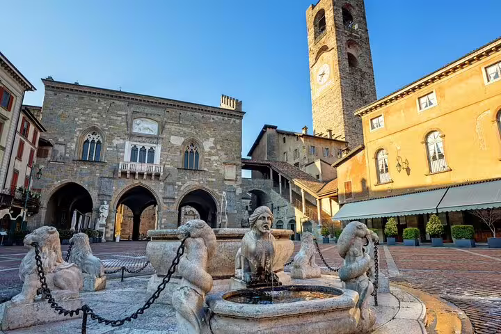 Piazza Vecchia fountain and Palazzo della Ragione in Bergamo Alta, ideal for a self-guided scavenger hunt tour
