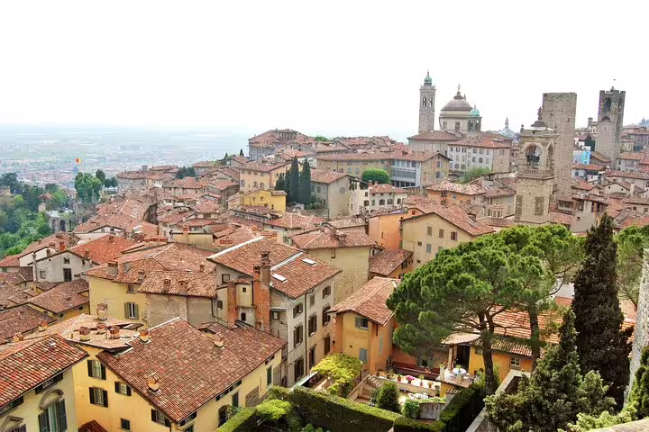 Daytime view over Bergamo Alta’s terracotta rooftops, towers and Duomo, featured on a 2.5-hour private walking tour