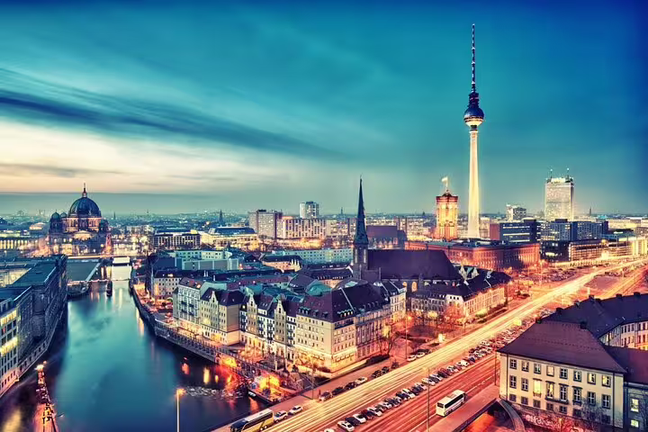 Berlin skyline at dusk with Fernsehturm TV Tower, River Spree, and illuminated city streets panoramic view