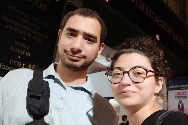 Two travelers posing together in front of Hackescher Markt in Berlin during a city walking tour