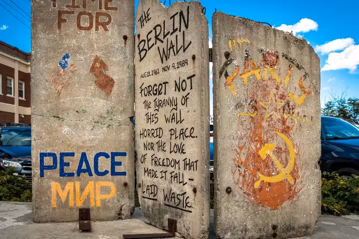 Sections of the Berlin Wall with Cold War graffiti including Peace, Soviet hammer and sickle symbols