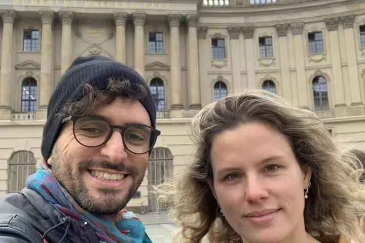 Couple smiling in front of Humboldt University during Berlin walking tour
