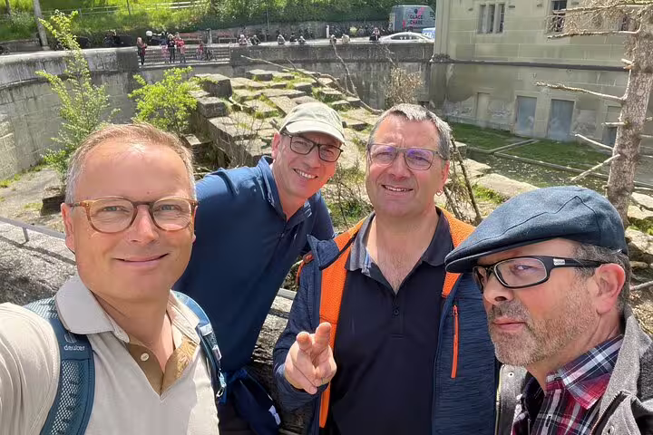 Group selfie by the Aare River in Bern during a self-guided scavenger hunt and sightseeing walking tour