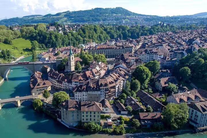 Aerial view of Bern old town peninsula surrounded by turquoise Aare River, Switzerland