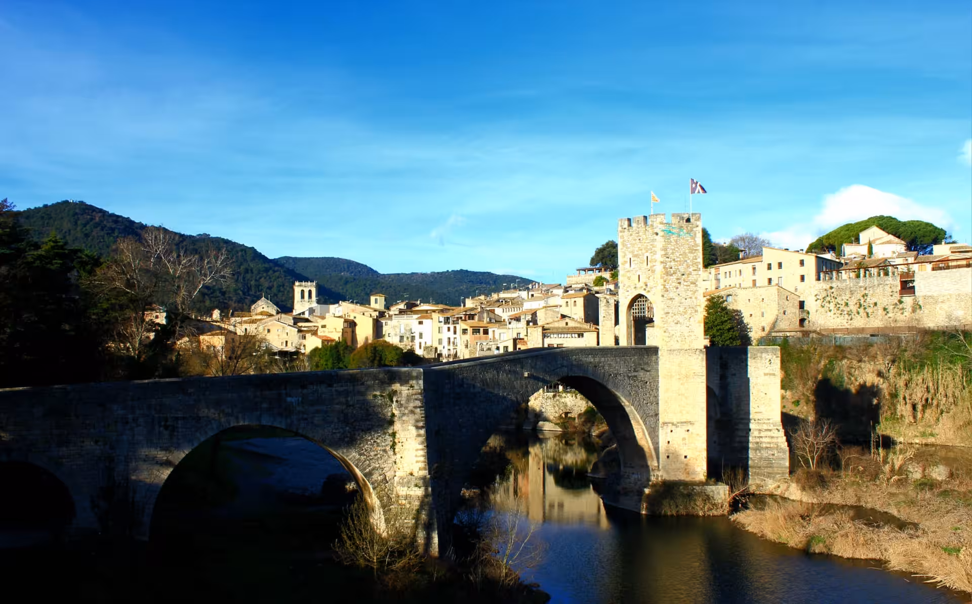 Scenic view of Besalú Romanesque bridge over the Fluvià River, highlight of a private Garrotxa tour