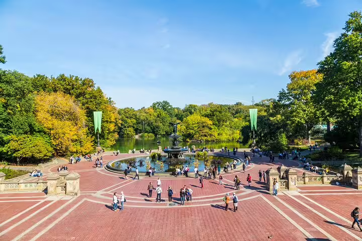 Bethesda Fountain and Terrace in Central Park NYC with visitors strolling on a sunny autumn day