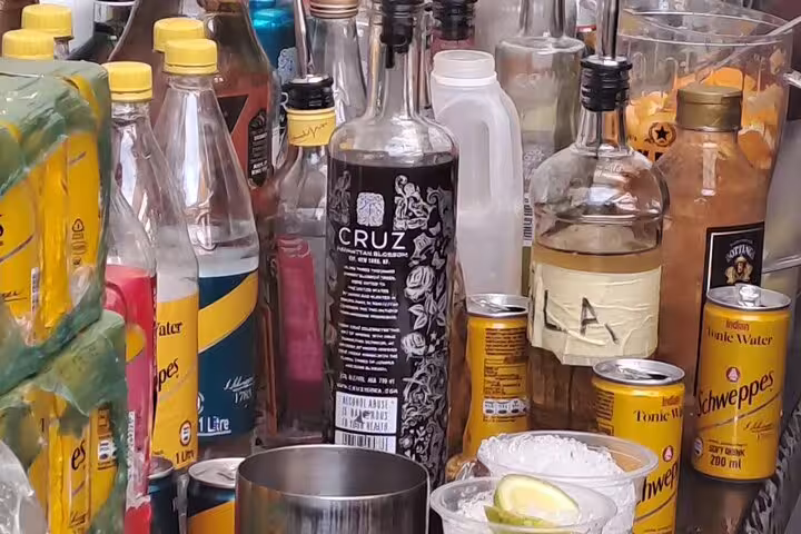 Assortment of beverage bottles and mixers ready for tasting on a vibrant 3-hour food and drink tour.