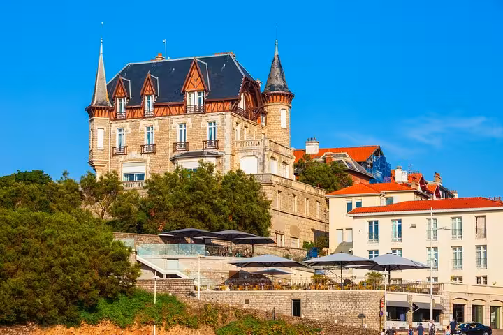 Historic castle-like building in Biarritz under a clear blue sky, featured in a private city walking tour.