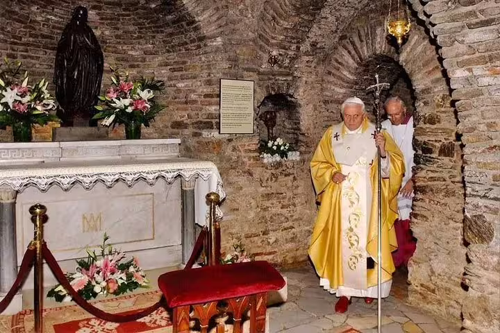 A religious figure in ceremonial attire inside a chapel at the House of the Virgin Mary on a Biblical Ephesus tour.