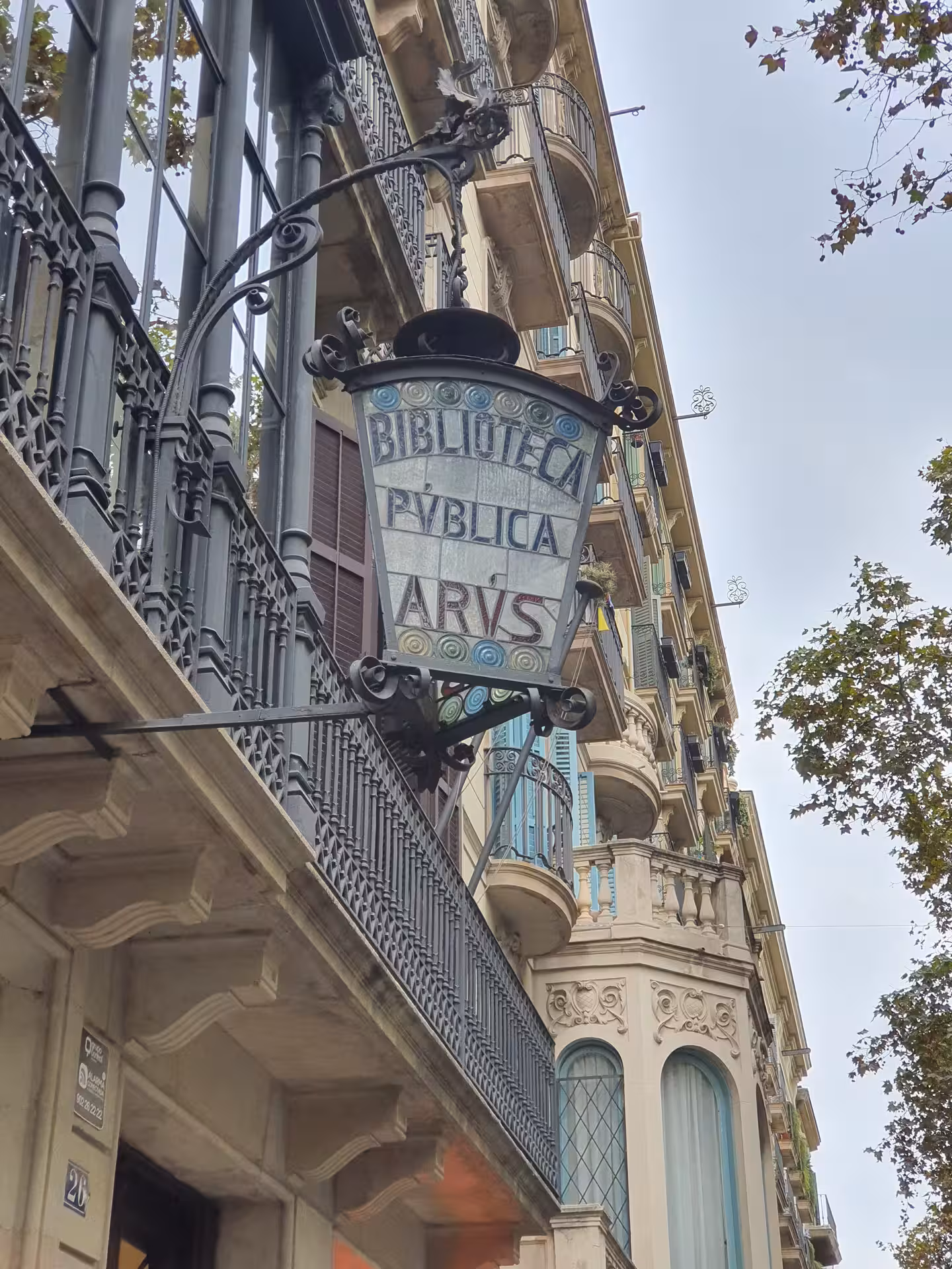 Ornate Biblioteca Pública Arús sign on historic building, highlighting architectural beauty on La Barcelona masónica tour.