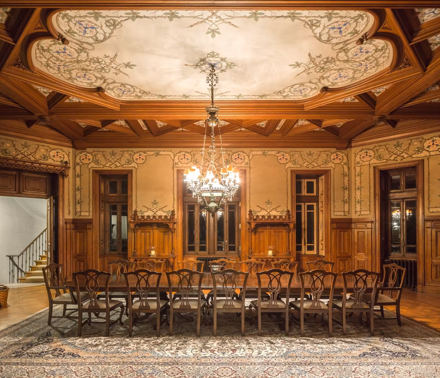 Grand dining hall interior of Biester Palace Sintra with floral painted ceiling and long wooden table