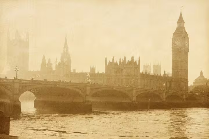 Sepia-toned view of Big Ben and Westminster Bridge over the River Thames in foggy London
