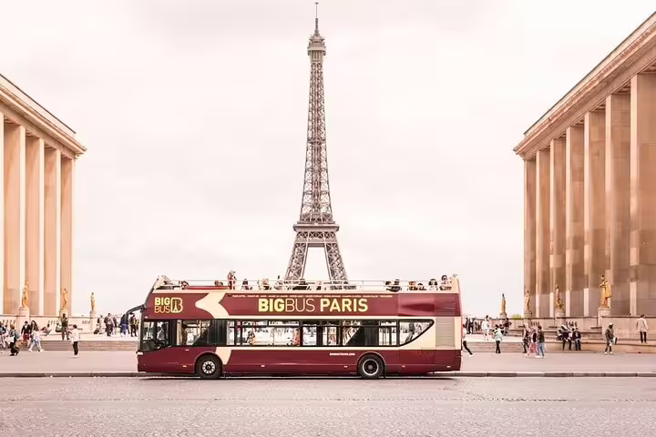 Big Bus Paris hop-on hop-off double-decker tour bus in front of the Eiffel Tower at Trocadéro