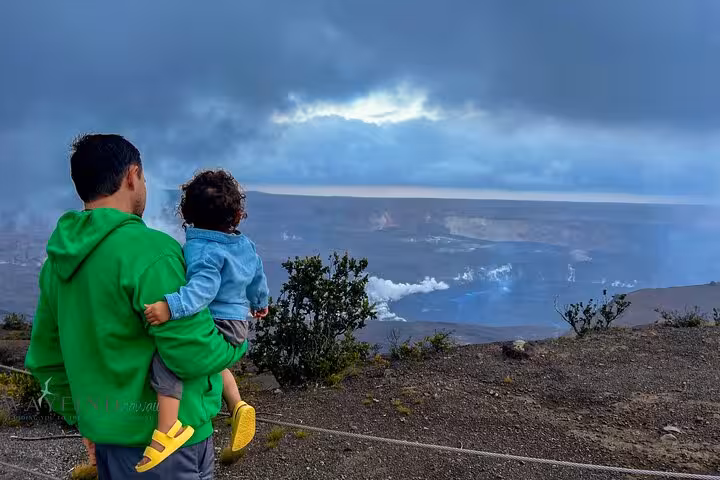 Father and child observing volcanic landscape on Hawaii's Big Island, a highlight of the Volcano, Waterfalls & Coffee Tour.