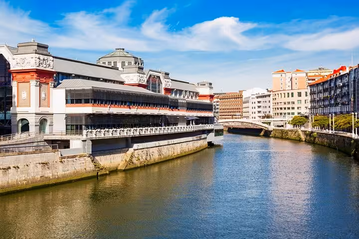 Historic Bilbao’s Mercado de la Ribera along the Nervión River, showcasing architectural charm and urban beauty.