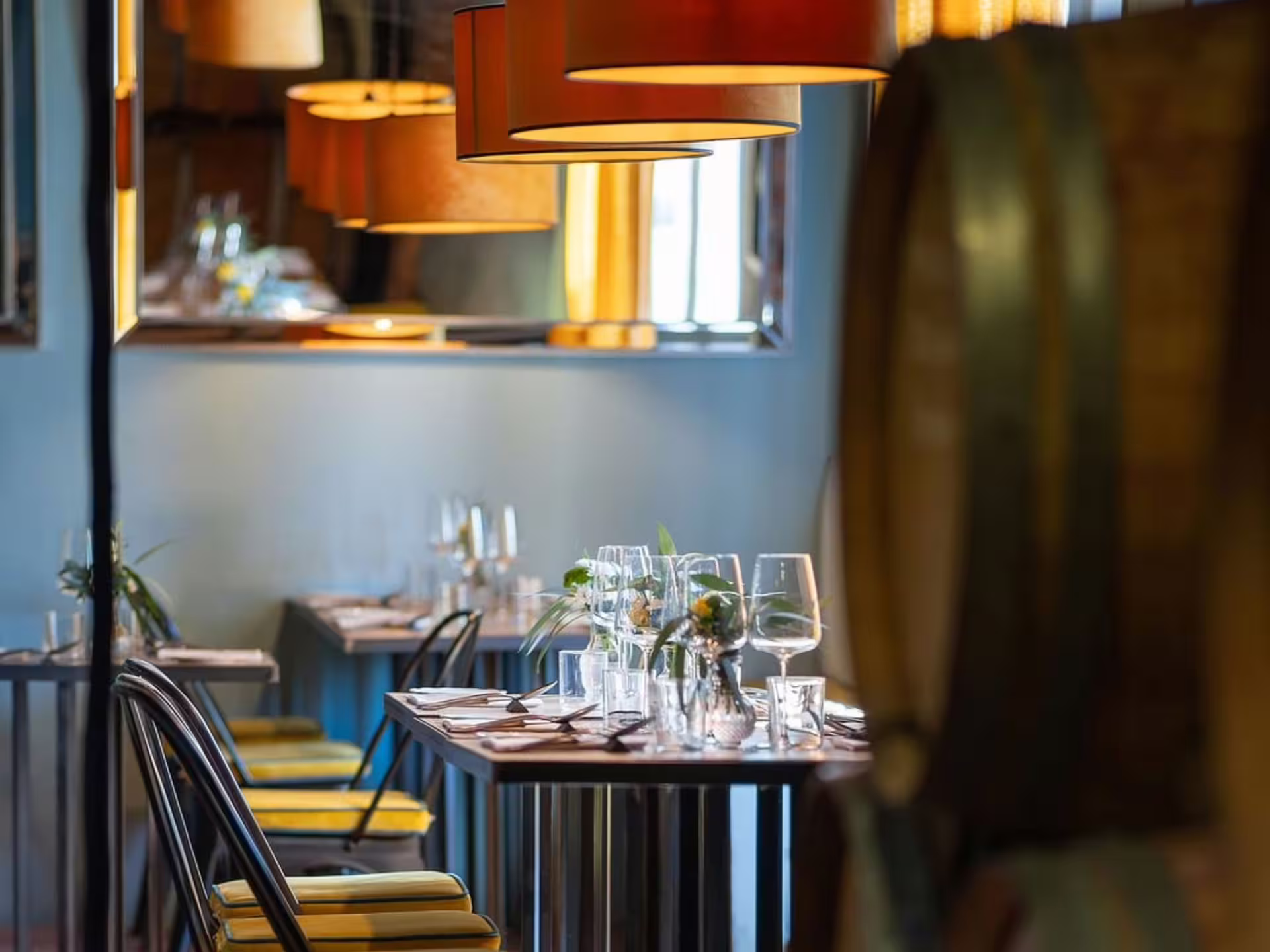 Elegant dining setup with wine glasses and decor in a cozy tasting room at a biodynamic winery in Lucca.