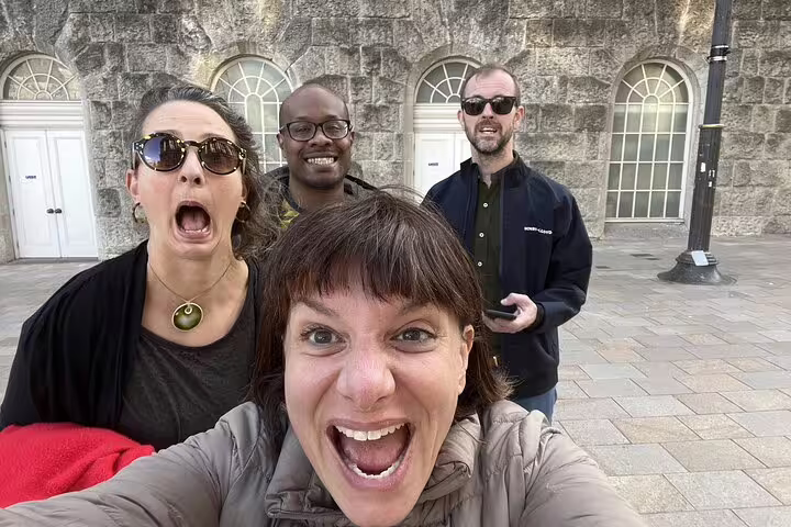 Four excited tourists taking a selfie during a ghost hunt walking tour in Birmingham