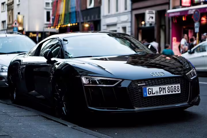 Black Audi R8 luxury chauffeur car parked on a city street in Frankfurt