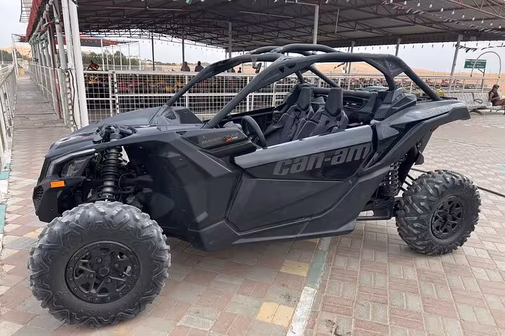 Black Can-Am dune buggy at desert staging area, 4x4 off-road vehicle for guided dune buggy quad bike tour