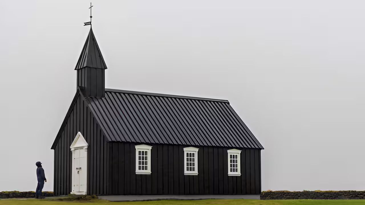 Black wooden church with steeple and white windows on Snaefellsnes Peninsula, Iceland