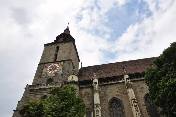 Black Church Gothic tower with ornate clock face in Brasov Old Town, Romania