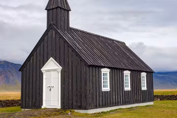 Black wooden church with white door and windows on Snaefellsnes Peninsula, Iceland
