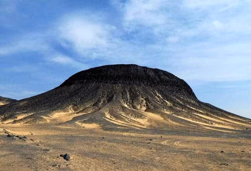 Black Desert Egypt volcanic hill and sweeping sands, scenic stop on 15-day Cairo, White Desert and Nile cruise