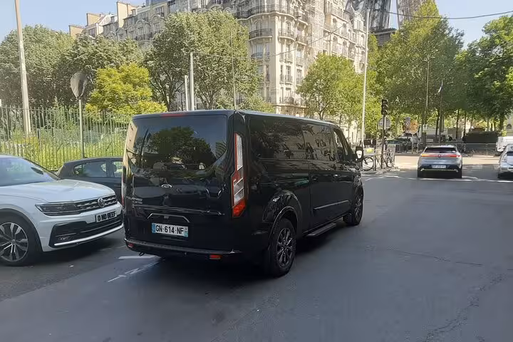 Black Ford Transit van on Paris street for private airport transfer service