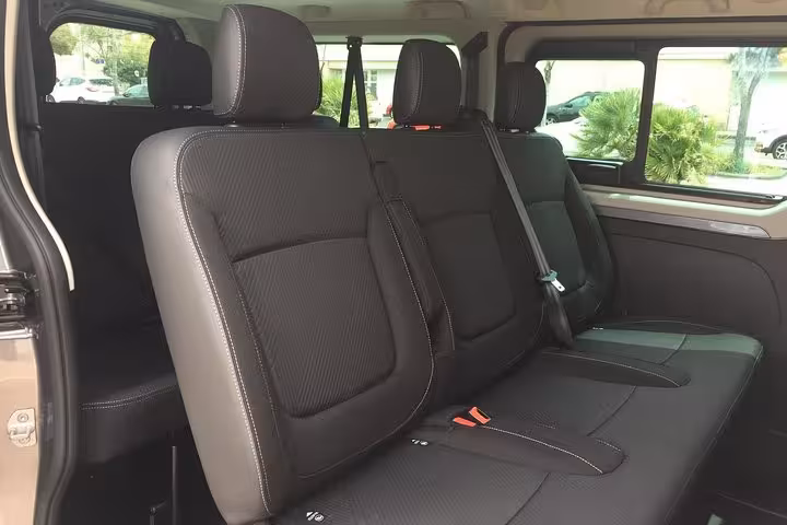 Spacious black leather minivan seats for private transfer Marseille to Arles with comfortable legroom