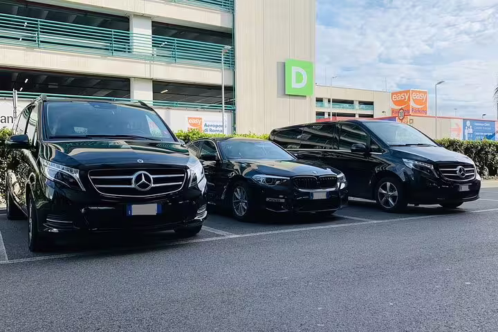 Fleet of black luxury vehicles at airport for private transfer service from Orly Airport ORY to Paris