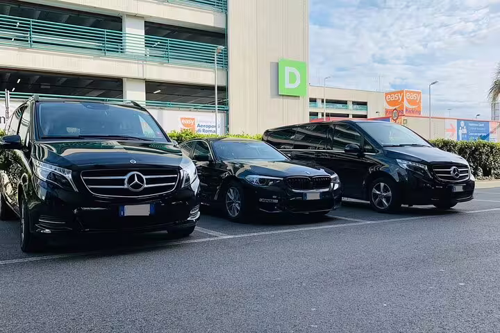 Fleet of black luxury Mercedes and BMW vehicles parked at airport for private Berlin BER round-trip transfers