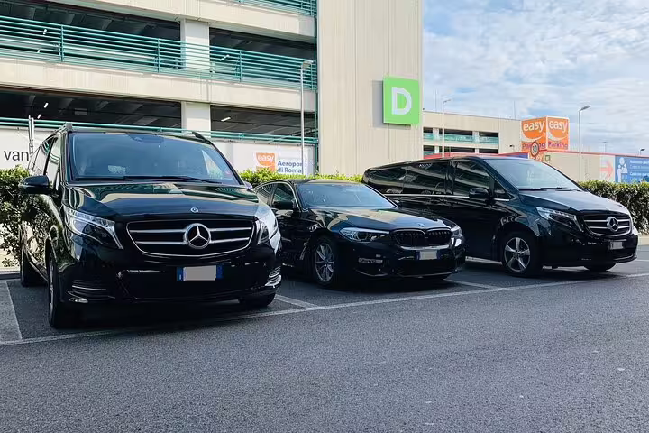 Fleet of black luxury Mercedes vans and BMW sedan parked at Valencia Airport VLC for private transfer service