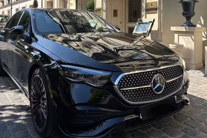 Black Mercedes-Benz luxury sedan parked outside elegant building for private shore excursion transfer