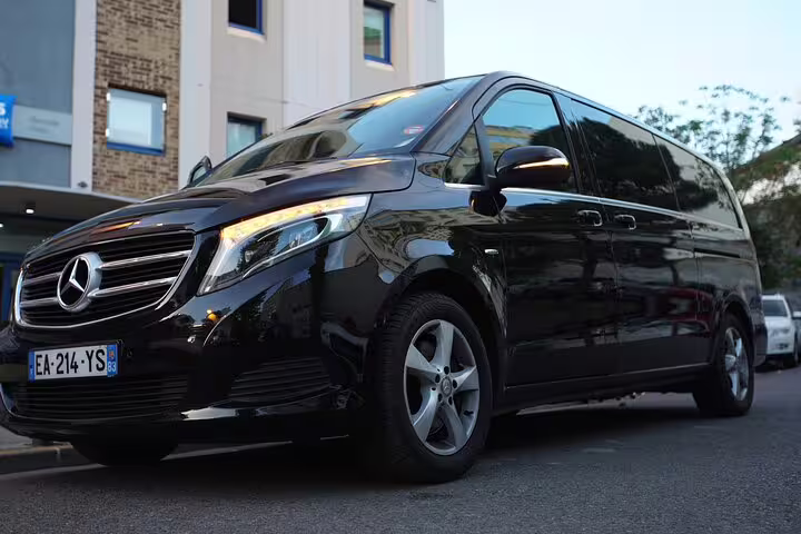 Black Mercedes-Benz luxury van parked outside hotel with French license plate EA-214-YS