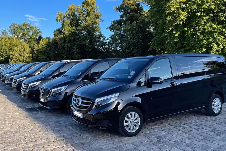 Fleet of black Mercedes-Benz V-Class luxury vans parked in a row for private tours