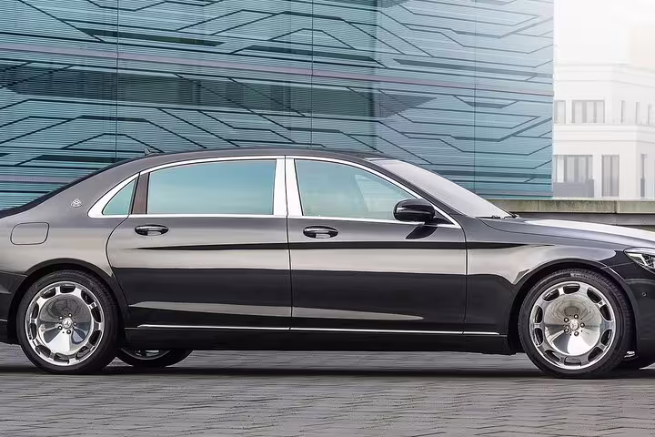 Black Mercedes-Maybach luxury sedan side view for private transfer service