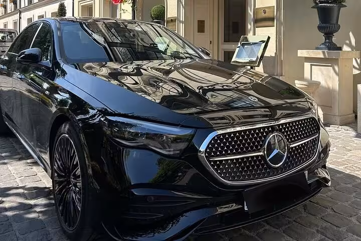 Black Mercedes-Benz luxury sedan parked outside elegant building for private tour service