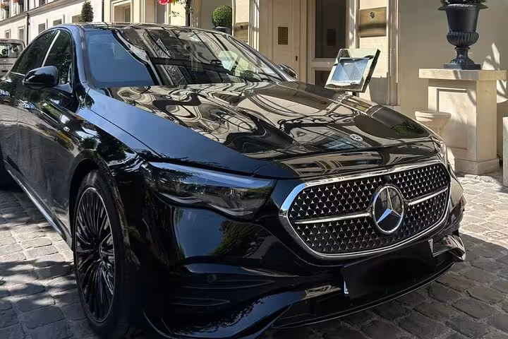 Black Mercedes-Benz luxury sedan parked outside elegant building for private shore excursion transfer