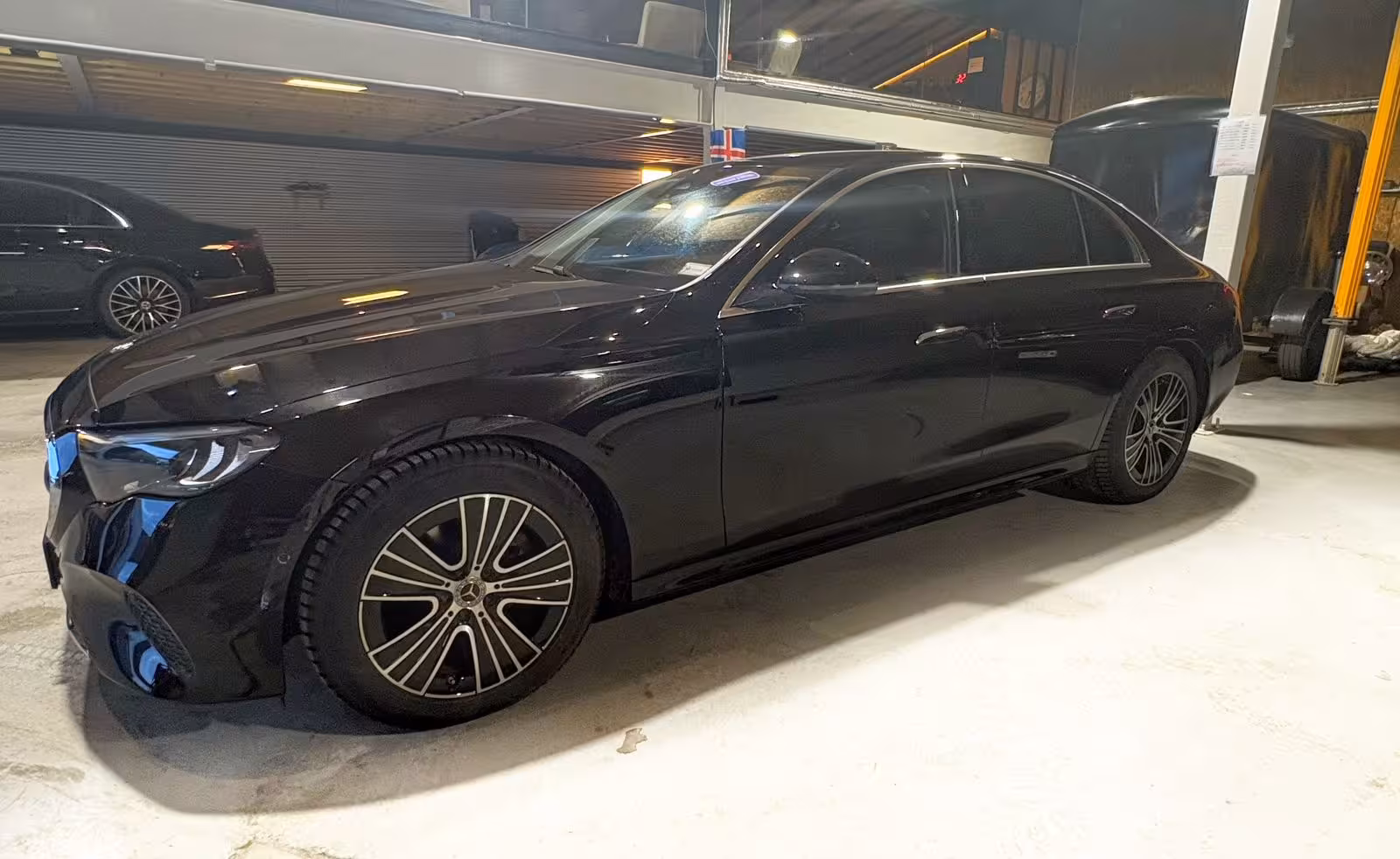 Black Mercedes-Benz sedan parked indoors for private transfer from Keflavik Airport to Reykjavik